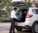 Professional driver loading luggage into a family car before an outstation trip from Bangalore
